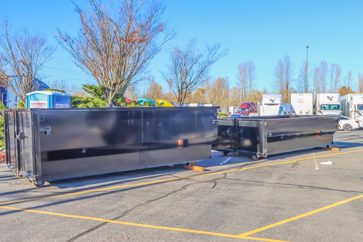 Professional dumpster rental service with roll-off container on residential driveway in Hilmar-Irwin